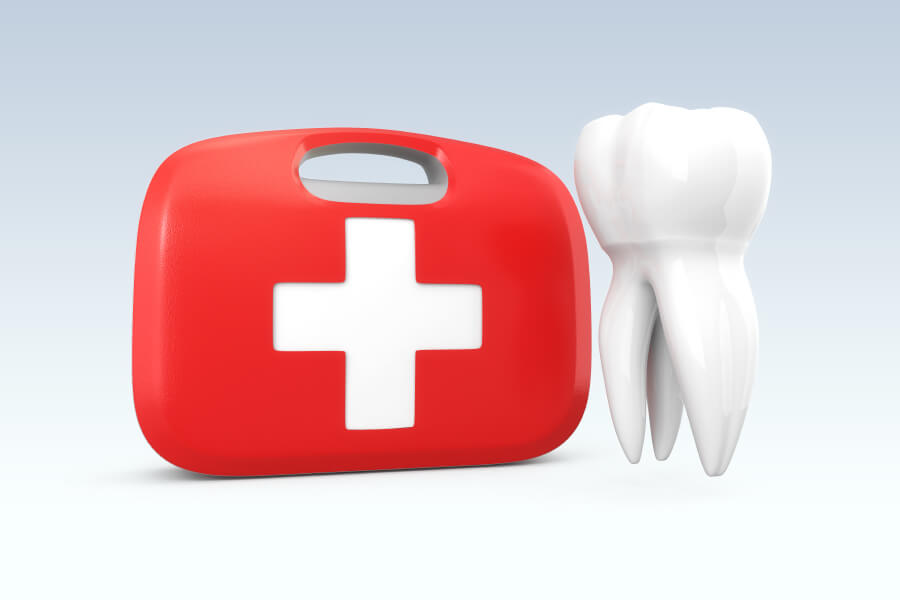 A tooth next to a red and white first aid kit to indicate care for a dental emergency